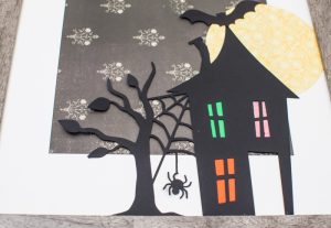 Spooky Halloween Frame - I hate the scary aspect of Halloween so I typically don't decorate for the holiday. But I found the perfect non-scary Silhouette file and paired it with my paper banner to create a fun Halloween decoration that's more cute than spooky!