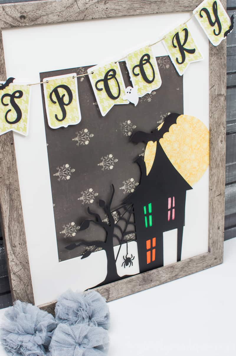 Spooky Halloween Frame - I hate the scary aspect of Halloween so I typically don't decorate for the holiday. But I found the perfect non-scary Silhouette file and paired it with my paper banner to create a fun Halloween decoration that's more cute than spooky!