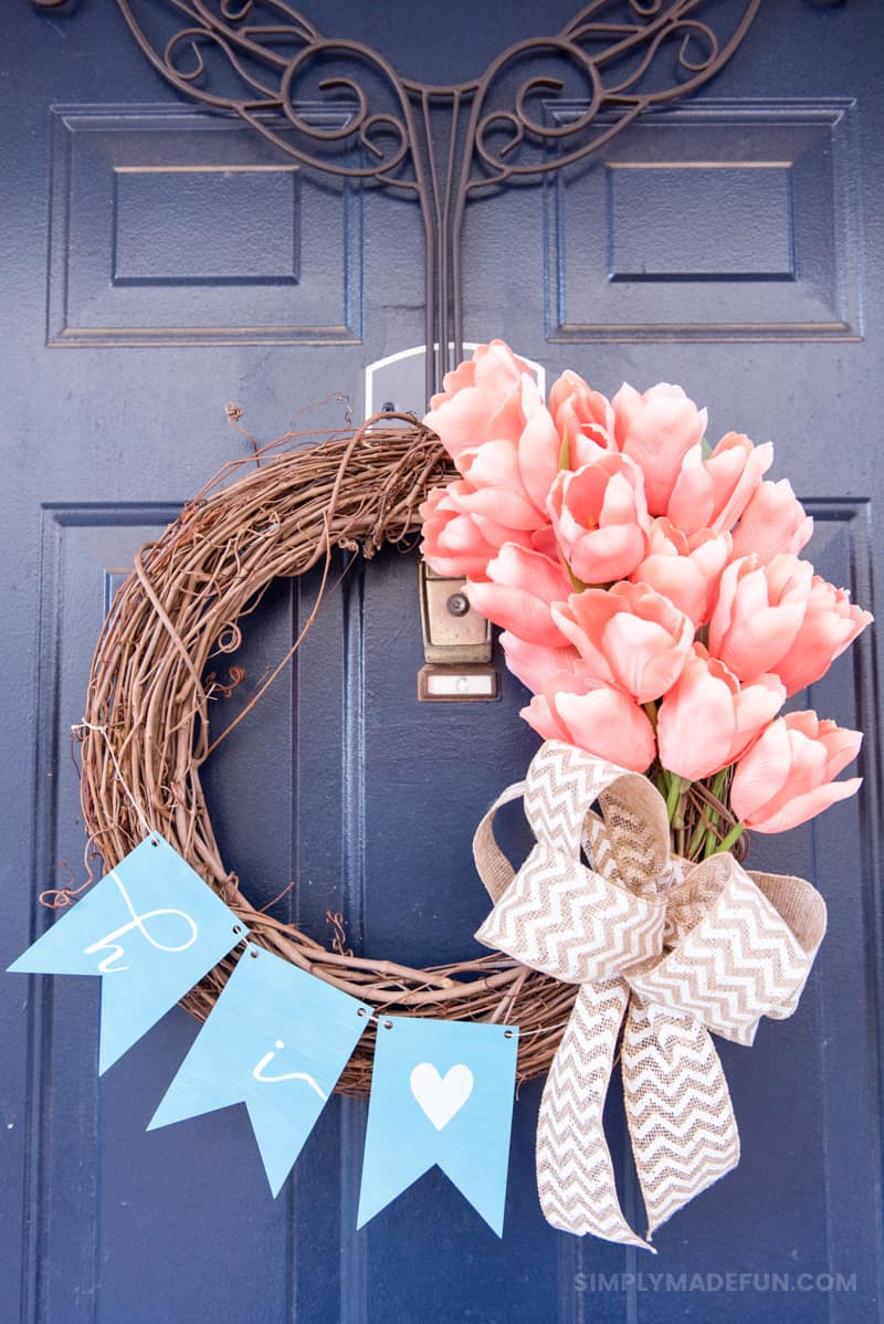 Easy Spring Tulip Wreath - Use silk flowers, burlap, a wood banner and your Silhouette Machine to create a gorgeous and unique wreath for your front door. It's so easy and the perfect 20 minute craft to DIY!