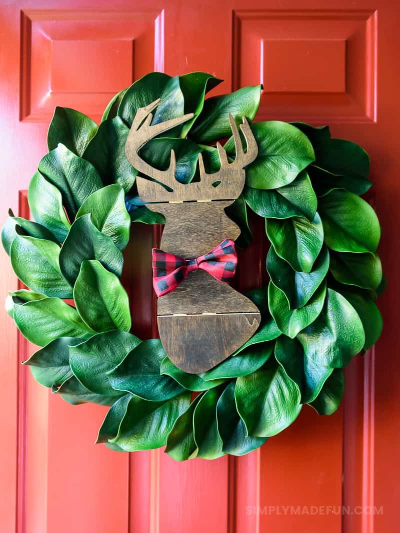 Easiest Holiday Wreath - When Christmas is over my house feels bare without all the decorations, so I grabbed a wooden deer from Hobby Lobby and put it on the wreath that was already on my door. It's a simple + quick DIY that requires 5 supplies (6 if you need a wreath!).