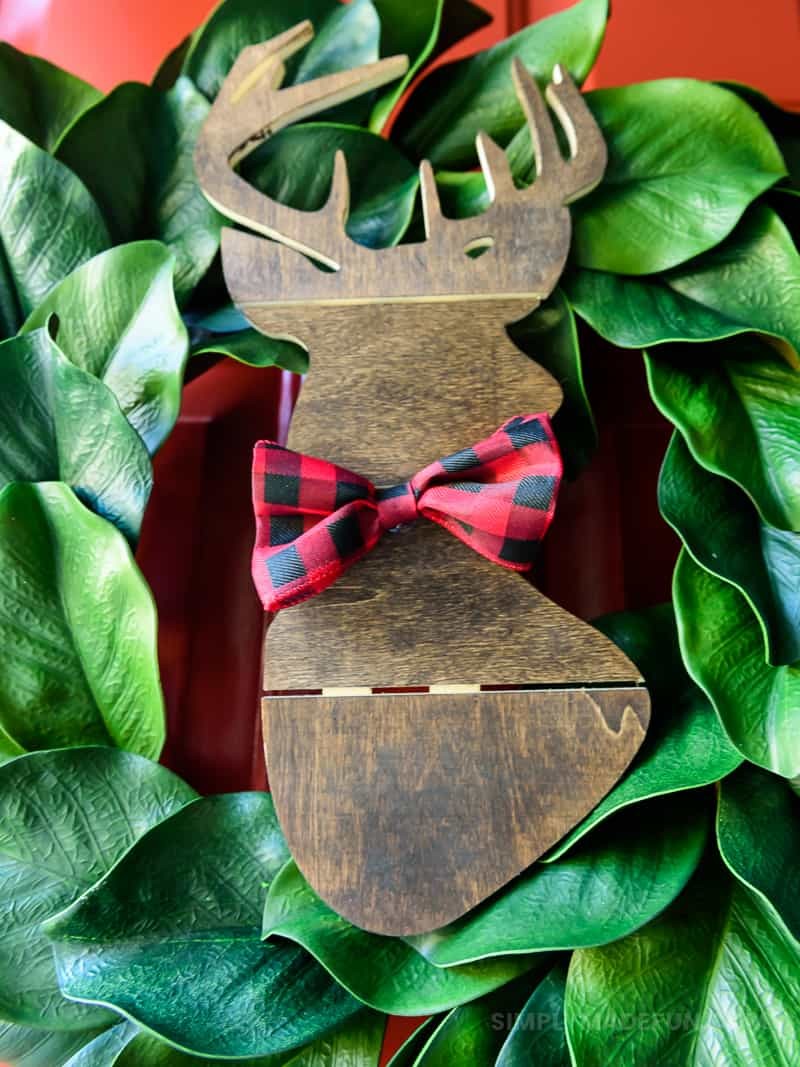Easiest Holiday Wreath - When Christmas is over my house feels bare without all the decorations, so I grabbed a wooden deer from Hobby Lobby and put it on the wreath that was already on my door. It's a simple + quick DIY that requires 5 supplies (6 if you need a wreath!).
