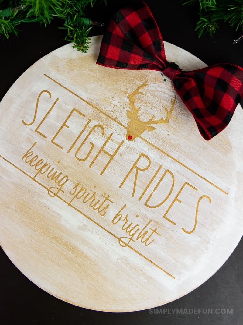 Rae Dunn Inspired Wooden Holiday Sign - After the Christmas decor comes down the whole house feels empty. Make some wall art that'll last all winter long with your Silhouette Machine and some stencil vinyl. This Rae Dunn holiday sign is the perfect rustic DIY for your home!
