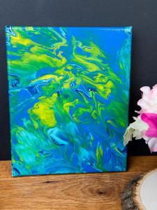 Acrylic Pour Canvas - This is one messy DIY but it is really fun to make too! You can get creative with color and design and no two art projects will be the same! It's the perfect art piece for your home that YOU made all on your own!
