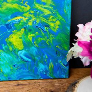 Acrylic Pour Canvas - This is one messy DIY but it is really fun to make too! You can get creative with color and design and no two art projects will be the same! It's the perfect art piece for your home that YOU made all on your own!