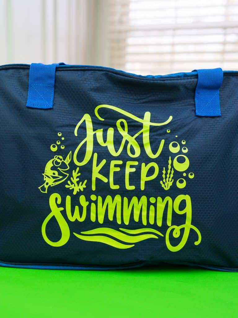 Just keep swimming Finding Nemo svg file on a polyester swim bag.