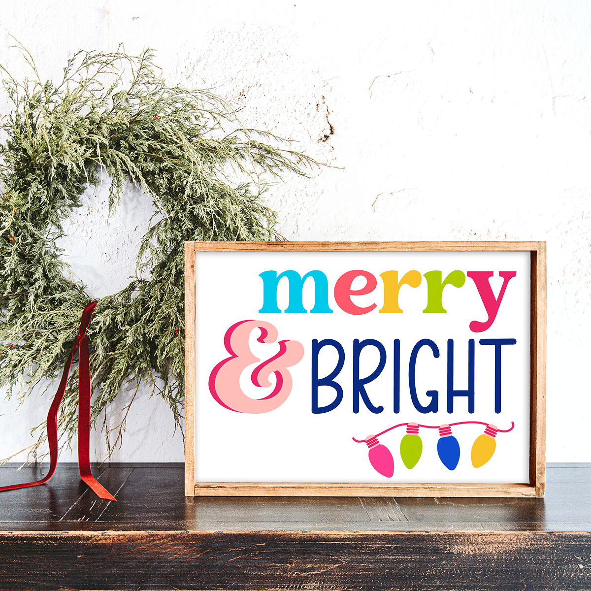 colorful merry and bright text with a string of Christmas lights below it