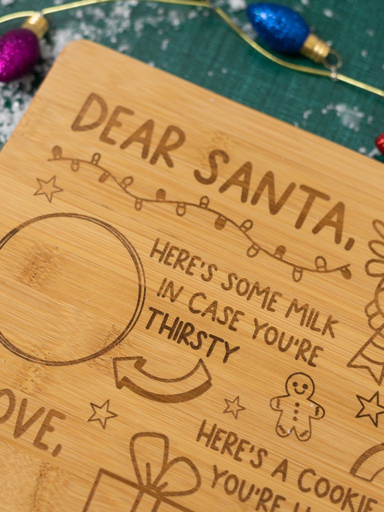 Up close image of the Cookies for Santa laser cut tray. Because of the wood I used you can see a variation in color where it was engraved. This is typical with most wood, especially bamboo.